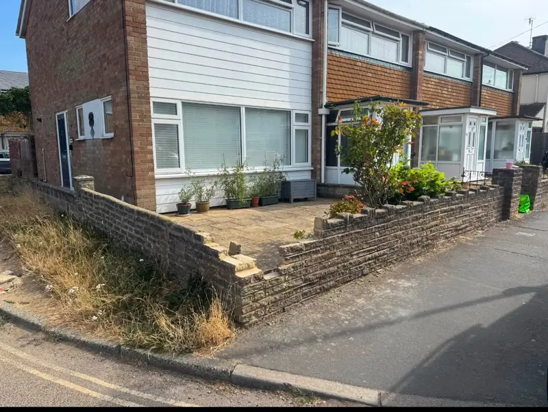 Old crumbling front garden wall before replacement